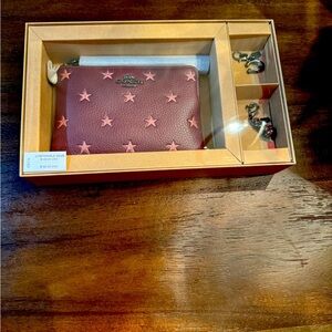 COACH, brand new in box!!!
Boxed Corner Zip Wristlet 
With Star Print And Charms